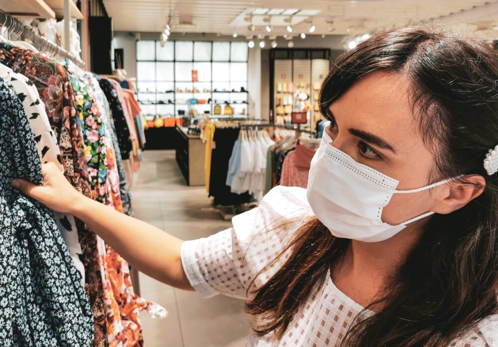 young woman in retail store wearing mask face mask 3KJ6TUT